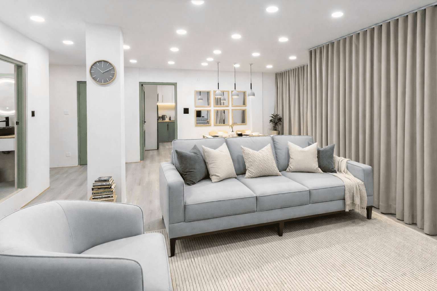 Tiny Living Apartment lounge — sofa, soft lighting and a corner armchair